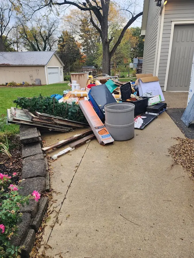 Dumpster being loaded with debris for Residential Dumpster Rental in Spring Hill